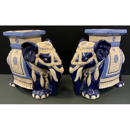 147 - A pair of Chinese jardiniere stands, as Elephants standing, 43cm high, 45cm long, 22cm wide