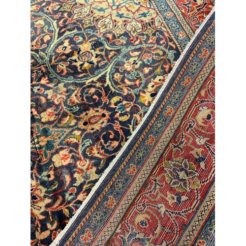 165 - A Persian Sarough rug / carpet, having a diamond shaped medallion within a central field densely wov... 