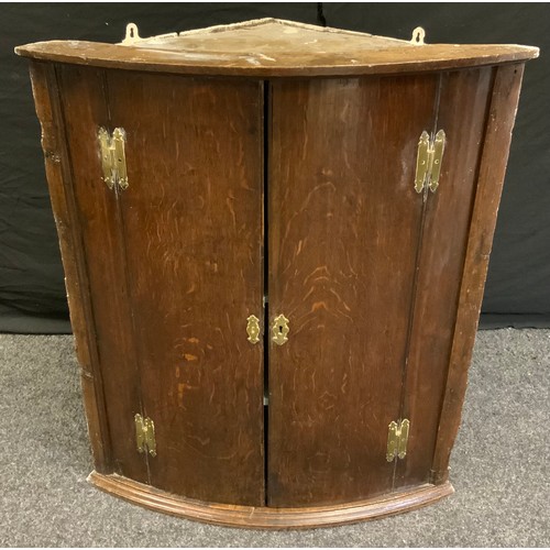 172 - A George III oak wall hanging corner cupboard, 86cm high, 74cm wide, c.1800