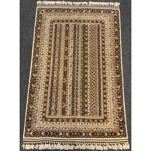 210 - A fine hand-made Telle Torkaman rug / carpet, woven in muted tones of umber, brown, and cream, 190cm... 