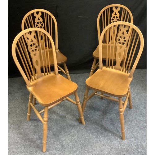 228 - A set of four Ercol style beech wheel back side chairs, saddle seats, H-stretchers.(4)