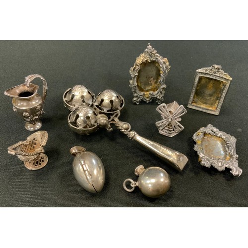 277 - A silver coloured metal babies whistle rattle, unmarked;   pair of miniature picture frames;  filigr... 