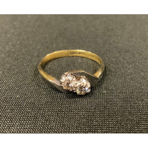 331 - A diamond twist ring, set with two old brilliant cut diamonds, total estimated diamond weight 0.26ct... 