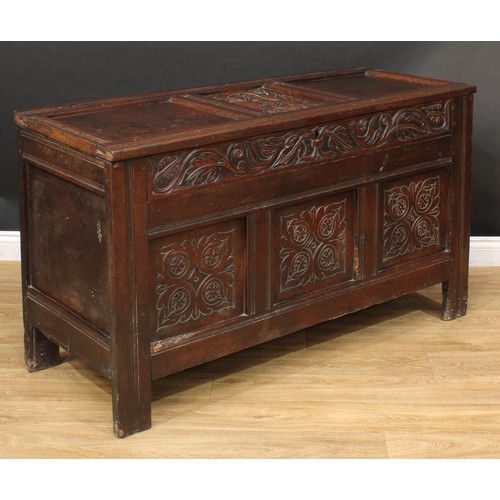 17 - An 18th century Jacobean design oak blanket chest or marriage chest, hinged three-panel top, the cen... 