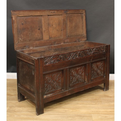 17 - An 18th century Jacobean design oak blanket chest or marriage chest, hinged three-panel top, the cen... 