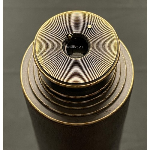 57 - A four draw Telescope in brass with sun shield and brown leather covering. Maker marked 