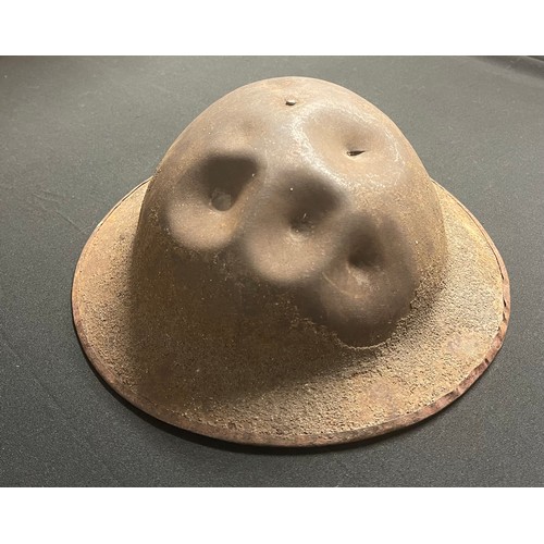 77 - WW1 British Brodie MKI Steel Helmet. Five bullet strikes to the front of the helmet one of which has... 