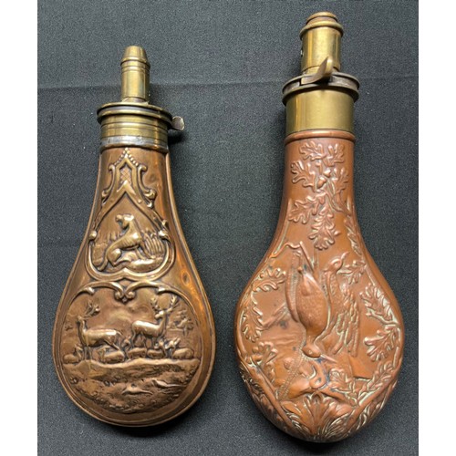 190 - A Brass and Copper Powder Flask embossed with a design of game birds and oakleaves. Four adjustable ... 