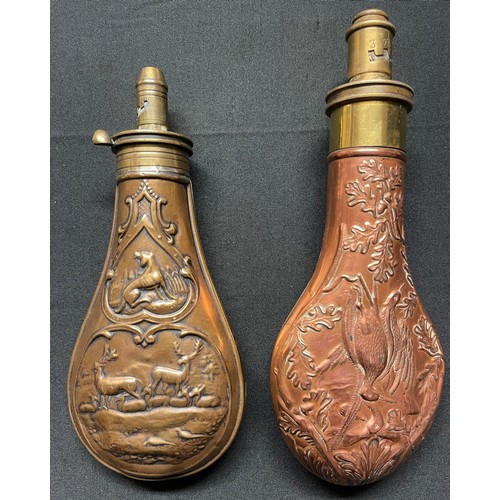 190 - A Brass and Copper Powder Flask embossed with a design of game birds and oakleaves. Four adjustable ... 