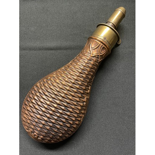 192 - A Brass and Copper Powder Flask embossed with a basket weave design. Four adjustable measures of bla... 