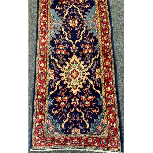 4 - A Fine Persian hand-made Sarough runner carpet, woven in shades of pale blue, red, and indigo, 423cm... 