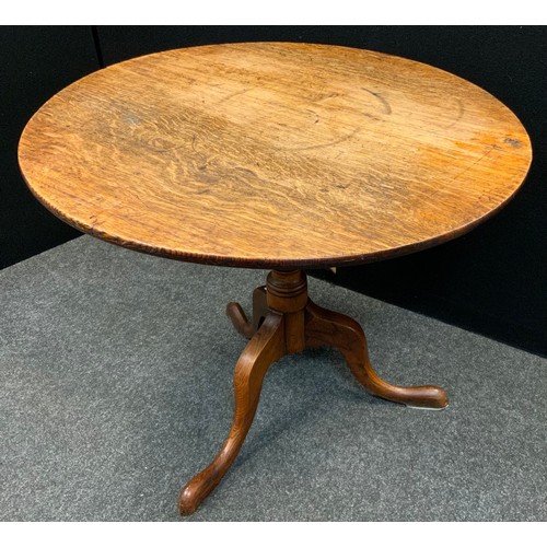 37 - A George III oak occasional table, the circular top tilting on turned columns, tripod base, 73cm hig... 