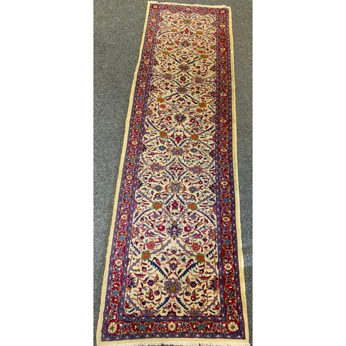 49 - A Fine Persian hand-made Brojerd runner carpet, woven in shades of red, mauve, and deep blue, on a c... 