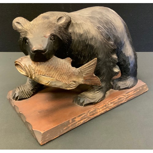 76 - A large 'Black Forest' Brown Bear, with salmon in his mouth, rectangular base, 38cm wide