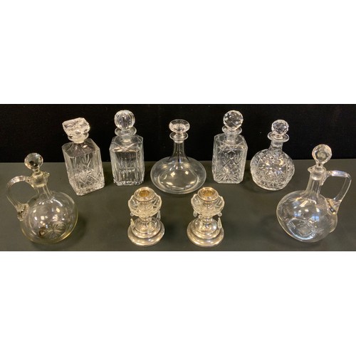 186 - Seven various decanters, including ship's,  some cut;   a pair of plated candlesticks, with lustres