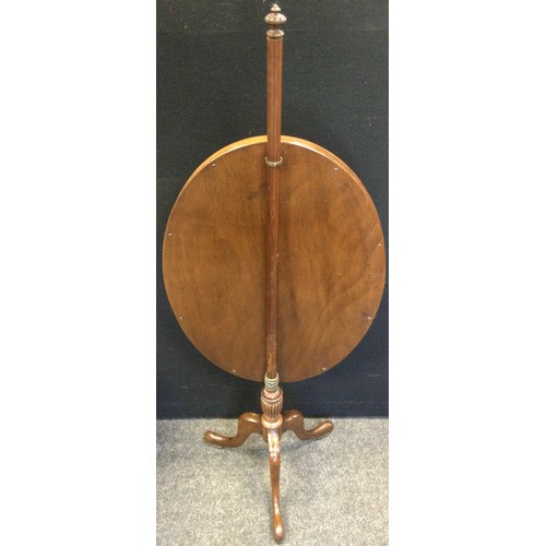 69 - A late Victorian mahogany pole screen, the glazed oval screen with an embroidered floral panel, trip... 