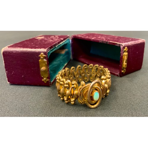 338 - An unusual opalescent stone and gold plated expanding bracelet, boxed.