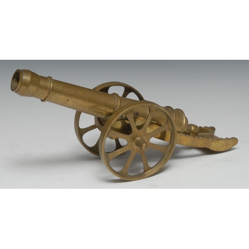 5066 - A brass model desk canon, 25cm barrel, spoked wheels, 33cm long overall