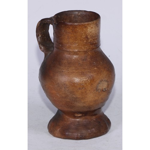 5139 - A Medieval pottery drinking jug, loop handle, pinched base, 14.5cm high, c.13th/14th century