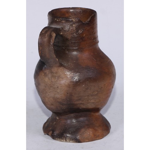 5139 - A Medieval pottery drinking jug, loop handle, pinched base, 14.5cm high, c.13th/14th century