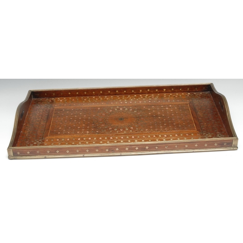 5271 - An Indian hardwood and marquetry gallery tray, profusely inlaid in copper and brass with leafy stems... 