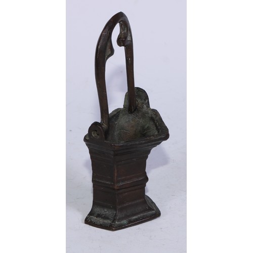 5110 - A Gothic bronze holy water stoup, the swing handle cast with tracery, 15.5cm high overall