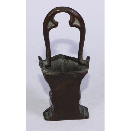 5110 - A Gothic bronze holy water stoup, the swing handle cast with tracery, 15.5cm high overall