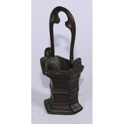 5110 - A Gothic bronze holy water stoup, the swing handle cast with tracery, 15.5cm high overall