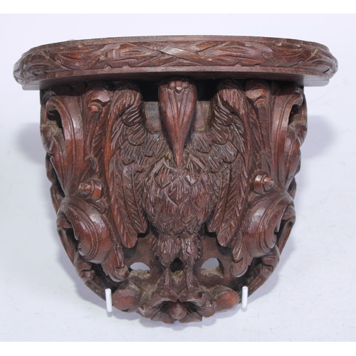 5163 - A pair of 19th century Anglo-Indian hardwood wall brackets, each carved with a pelican in her piety,... 