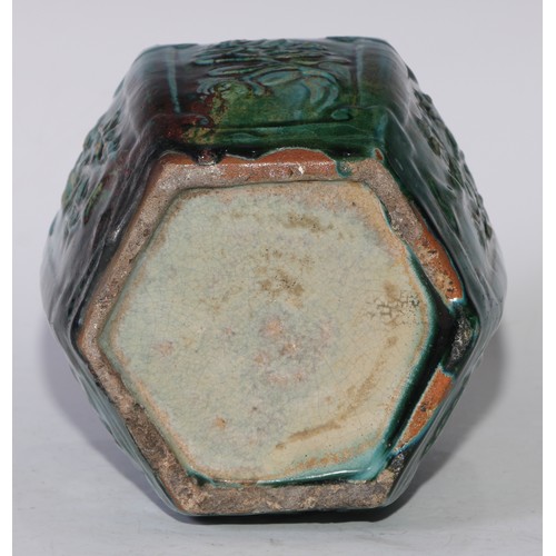 5076 - A Chinese monochrome hexagonal ginger jar, moulded in relief with prunus, bamboo and flowers, glazed... 