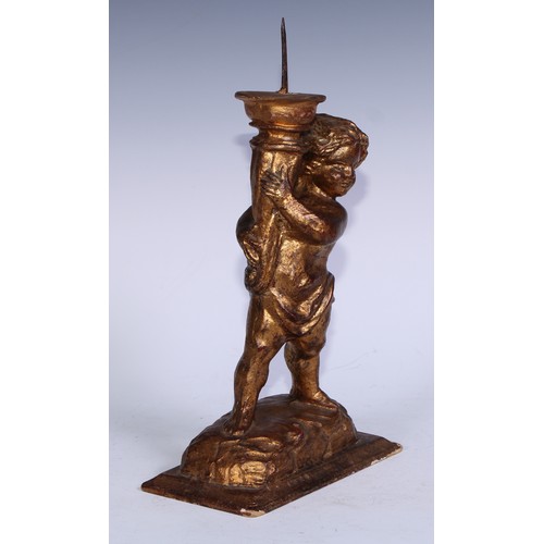 5301A - A Baroque design giltwood and gesso figural pricket candlestick, carved as a putto holding a cornuco... 