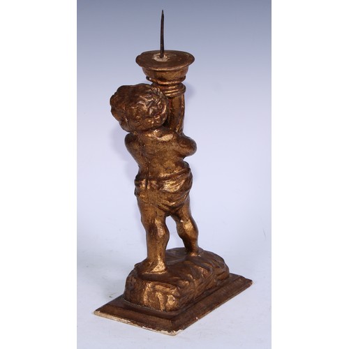 5301A - A Baroque design giltwood and gesso figural pricket candlestick, carved as a putto holding a cornuco... 