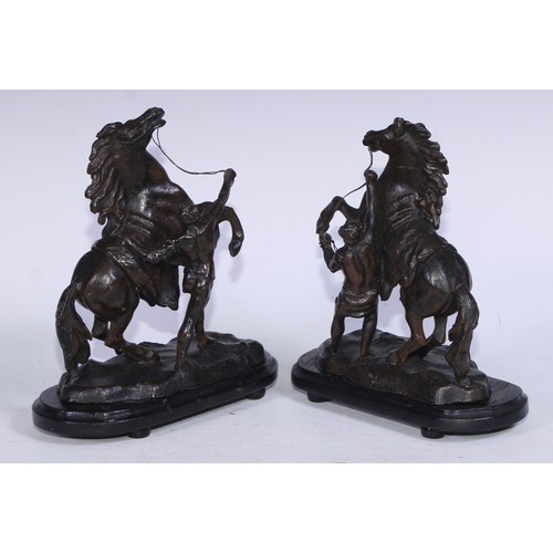 5231 - After Guillaume Coustou The Elder, a pair of dark patinated  Horse Tamer of Marly-le-Roi, ebonised b... 