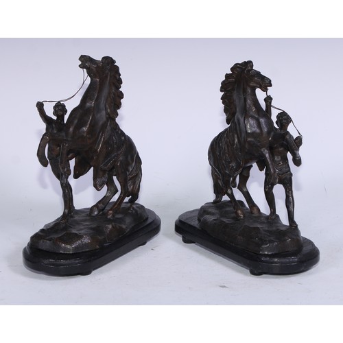 5231 - After Guillaume Coustou The Elder, a pair of dark patinated  Horse Tamer of Marly-le-Roi, ebonised b... 