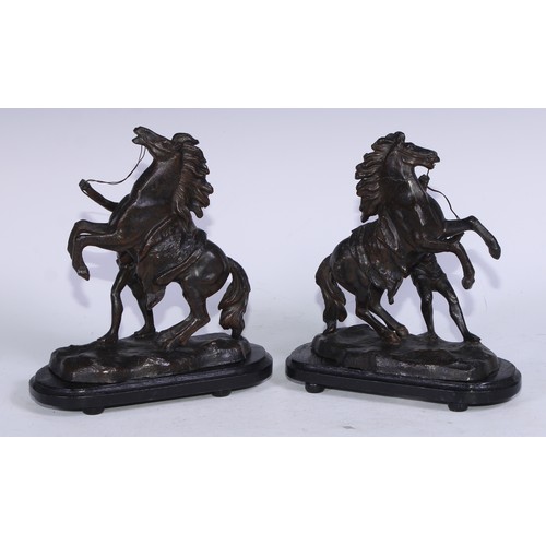 5231 - After Guillaume Coustou The Elder, a pair of dark patinated  Horse Tamer of Marly-le-Roi, ebonised b... 