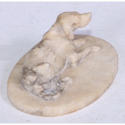 5324 - French School (19th century), an alabaster carving, of a recumbent dog, oval base, 12.5cm wide