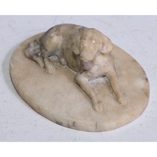 5324 - French School (19th century), an alabaster carving, of a recumbent dog, oval base, 12.5cm wide