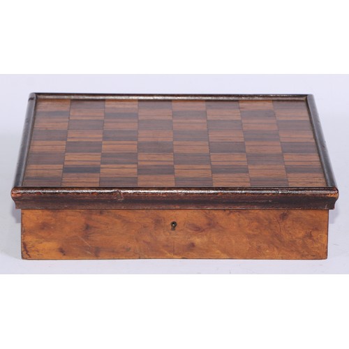 5245 - An Art Deco period walnut and parquetry games box, the hinged cover inlaid for chess, enclosing a fi... 