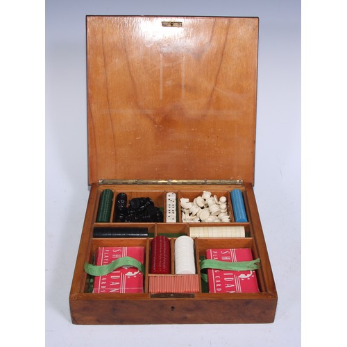 5245 - An Art Deco period walnut and parquetry games box, the hinged cover inlaid for chess, enclosing a fi... 