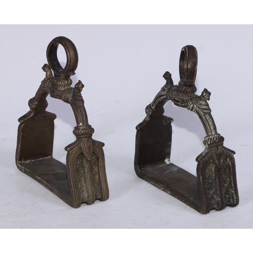 5182 - A pair of Mughal Indian bronze stirrups, cast in the Islamic taste with birds and chased with stiff ... 