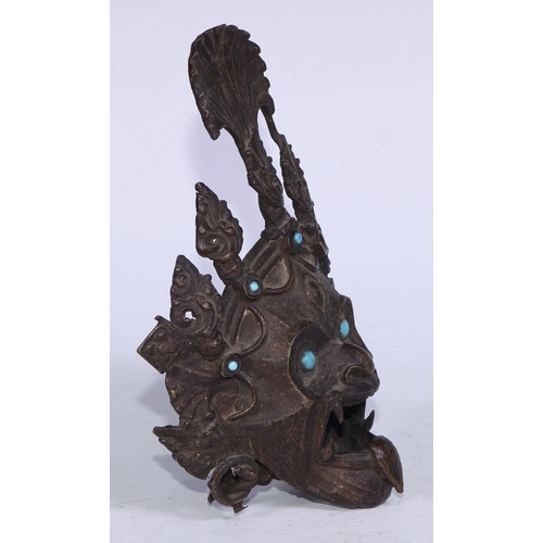 5209 - A Tibetan bronze demon-head censor, set with turquoise jewels and eyes,  19cm high