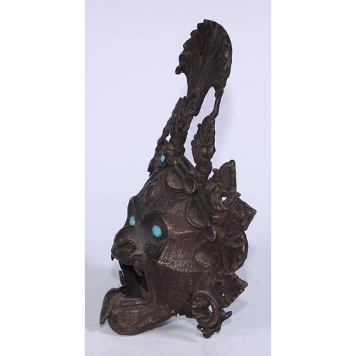 5209 - A Tibetan bronze demon-head censor, set with turquoise jewels and eyes,  19cm high