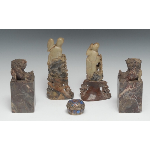 5178 - A pair of Chinese soapstone seals, carved with Dogs of Fo, the sides incised with sublime mountainou... 