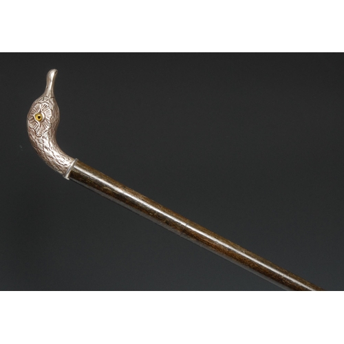 5261 - An early 20th century silver coloured metal mounted novelty walking stick, the handle as the head of... 