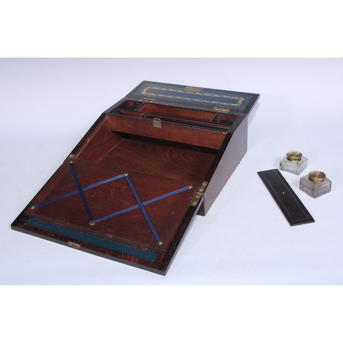 5109 - A George IV rosewood writing box or lap desk, the crossbanded top with hinged cover and fall front, ... 