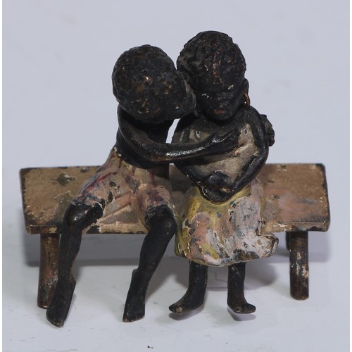 5172 - A pair of Austrian cold painted bronzes, of a young black boy and his reluctant sweetheart, seated o... 