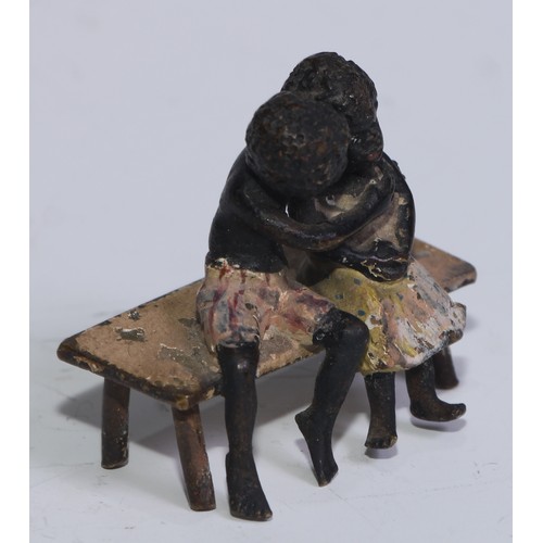 5172 - A pair of Austrian cold painted bronzes, of a young black boy and his reluctant sweetheart, seated o... 