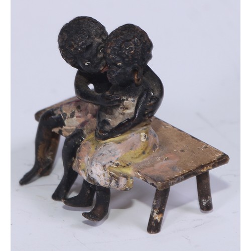 5172 - A pair of Austrian cold painted bronzes, of a young black boy and his reluctant sweetheart, seated o... 