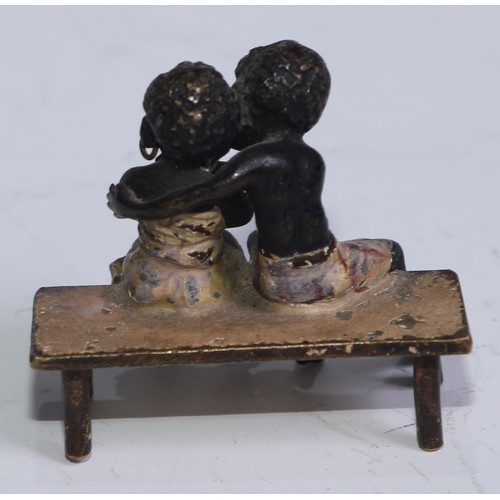 5172 - A pair of Austrian cold painted bronzes, of a young black boy and his reluctant sweetheart, seated o... 