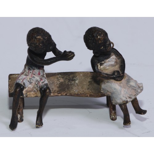 5172 - A pair of Austrian cold painted bronzes, of a young black boy and his reluctant sweetheart, seated o... 